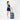 Woman holding a Sherpani Ciel Dolomite Duffle Luggage by roller handle against white backdrop.  #color_dolomite