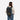 A woman wearing a Sherpani Camden Chromatic Black Ultimate Backpack on her back against white background.  #color_chromatic-black