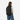 A Woman wearing a Sherpani Camden Raven Black Ultimate Backpack on her back against white background. #color_raven-black