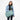 A woman wearing a Sherpani Camden Surf Blue Ultimate Backpack with crossbody strap against white background. #color_surf-blue