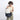 Woman holding a Sherpani Camden Terrazzo Print Backpack by top straps against white background.  #color_terrazzo-print