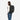 A woman wearing a Sherpani Crew Raven Black Travel Backpack on her back against a white background.  #color_raven-black