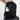 A Sherpani Getaway Raven Black Travel Backpack stacked on top of a Sherpani Meridian Carry-On Luggage.