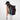 Woman wearing a Sherpani Juno Chromatic Black Duffel Backpack on her back against white backdrop.  #color_chromatic-black