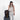Woman holding Sherpani Juno Chromatic Black Duffel Backpack on a Sherpani Meridian Granite Carry-On Luggage. #color_chromatic-black