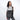 Woman holding Sherpani Soleil Granite Anti-theft Multi-Wear Travel Bag by Crossbody straps on white backdrop. #color_granite-grey