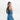 A woman wearing a Sherpani Wayfarer Chromatic Black Convertible Sling on her front against white background.  #color_chromatic-black