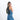 A woman wearing a Sherpani Wayfarer Chromatic Black Convertible Sling on her front against white background.  #color_chromatic-black