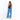 A woman wearing a Sherpani Wayfarer Chromatic Black Convertible Sling on her back against white background. #color_chromatic-black