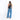 A woman wearing a Sherpani Wayfarer Chromatic Black Convertible Sling on her back against white background.  #color_chromatic-black