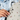 Person locking front zipper on a Sherpani Wayfarer Terrazzo Print Convertible Sling. 