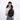 A woman wearing a Sherpani Wayfarer Raven Black Convertible Sling on her front against white background.  #color_raven-black