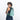 A woman wearing a Sherpani Wayfarer Surf Blue Convertible Sling on her front against white background.  #color_surf-blue