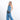 Woman wearing a Sherpani Hyk Chromatic Black Hip Pac on her hip against white backdrop.  #color_chromatic-black