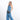 Woman wearing a Sherpani Hyk Chromatic Black Hip Pack on her hip against white backdrop.   #color_chromatic-black