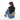 Woman wearing a Sherpani Hyk Dune Hip Pack across her back against white backdrop. #color_dune-tan