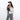 Woman wearing a Sherpani Hyk Raven Black Hip Pack across her body against white backdrop.  #color_raven-black