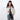 Woman holding a Sherpani Izzie Raven Black Water Bottle Crossbody by handheld straps on white background.  #color_raven-black
