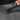 Person locking the zipper on a Sherpani Mei Granite Grey Anti-theft Travel Trio Crossbody. 