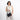 Woman holding a Sherpani Mei Carbon Black Anti-theft Travel Trio Crossbody by the short strap against white backdrop. #color_carbon-black