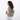 A woman wearing a Sherpani Metro Aloe Mist Green Anti-theft Reversible Sling on her back against a white background.  #color_aloe-mist-green