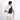 A man wearing a Sherpani Metro Carbon Black Anti-theft Reversible Sling on her back against a white background.  #color_carbon-black