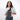 Woman wearing a Sherpani Metro Granite Anti-theft Reversible Sling on her front against white backdrop.  #color_granite-grey