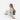 Woman sitting with a Sherpani Metro Passport Anti-theft Reversible Sling on her back against white backdrop. #color_passport-print