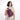 Woman wearing a Sherpani Metro Smoky Orchid Anti-theft Reversible Sling on her front against white backdrop. #color_smoky-orchid-pink