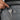 Person placing key on the keychain inside a Sherpani Prima Granite Grey Travel Crossbody. 