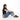 A woman sitting with a Sherpani Rogue Dune Mini Crossbody against white background.   #color_dune-tan