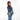 Woman wearing a Sherpani Rogue Olivine Mini Crossbody on her shoulder against white background.   #color_olivine-green