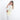 Woman wearing a Sherpani Rogue Sol Yellow Mini Crossbody on her shoulder against white background. #color_sol-yellow