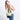 Woman wearing a Sherpani Sadie Palm Green Crossbody Bag on her shoulder against white backdrop. #color_palm-green