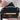 Woman placing a passport into a Sherpani Skye Chromatic Black Shoulder Bag. 