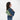 Woman wearing a Sherpani Skye Olivine Shoulder Bag by short strap against white backdrop. #color_olivine-green