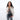 Woman holding a Sherpani Skye Raven Black Shoulder Bag by short strap against white backdrop. #color_raven-black