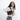 Woman wearing a Sherpani Skye Raven Black Shoulder Bag by short strap against white backdrop. #color_raven-black