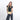 Woman wearing a Sherpani Skye Sol Yellow Shoulder Bag against white backdrop. #color_sol-yellow