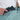 Person placing a passport inside of a  Sherpani Jaunt Surf Blue Garment Duffle. 
