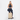 Woman holding a Sherpani Meridian Chai Beige Carry-On Luggage by the handle against white backdrop. #color_chai-beige
