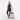 Woman holding a Sherpani Meridian Chai Beige Carry-On Luggage by the handle against white backdrop. #color_chai-beige