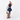 Woman holding a Sherpani Meridian Chai Beige Carry-On Luggage by the handle against white backdrop. #color_chai-beige