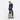 Woman holding a Sherpani Meridian Matcha Carry-On Luggage by the handle against white backdrop. #color_matcha-green