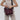 Woman shows features of Sherpani Vale Smoky-Orchid Pink Anti-theft Reversible Crossbody, such as RFID pocket & bag reversability.
