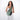 A woman wearing a Sherpani Esprit Aloe Mist Green Anti-theft Sling Bag on her front against a white background. #color_aloe-mist-green