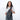 A woman wearing a Sherpani Esprit Granite Anti-theft Sling Bag on her front against a white background. #color_granite-grey