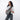 Woman wearing a Sherpani Esprit Houndstooth Anti-theft Sling on her front against white backdrop.  #color_houndstooth-print
