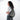 Woman wearing a Sherpani Esprit Houndstooth Anti-theft Sling on her back against white backdrop.  #color_houndstooth-print