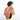 Woman wearing a Sherpani Esprit Desert Pink Sling on her back against white backdrop. #color_desert-pink